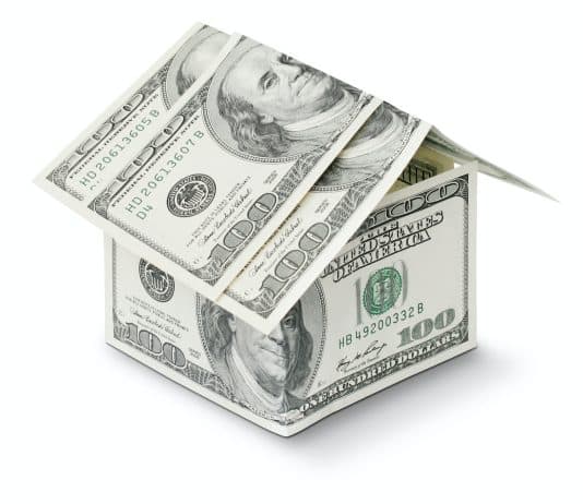 a house made out of money on a white background