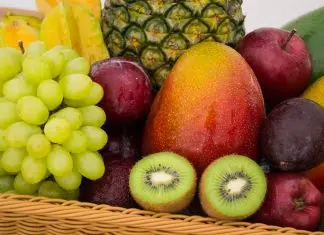 red apple fruit beside green apple and yellow fruit on brown woven basket