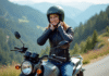 Les meilleures motos neuves de 125 cm³ homologuées pour 2025 Jeune femme en moto sur un panorama de montagne