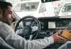 man in gray sweater driving car