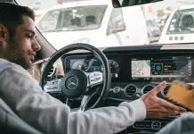 man in gray sweater driving car
