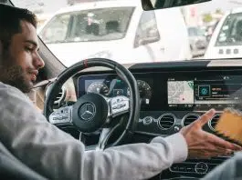 man in gray sweater driving car