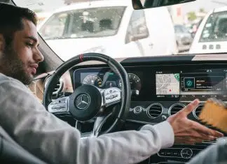 man in gray sweater driving car